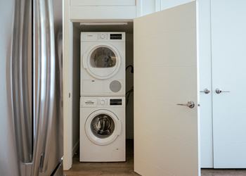 a small laundry room with a washer and dryer at Sky on Main in Kansas City